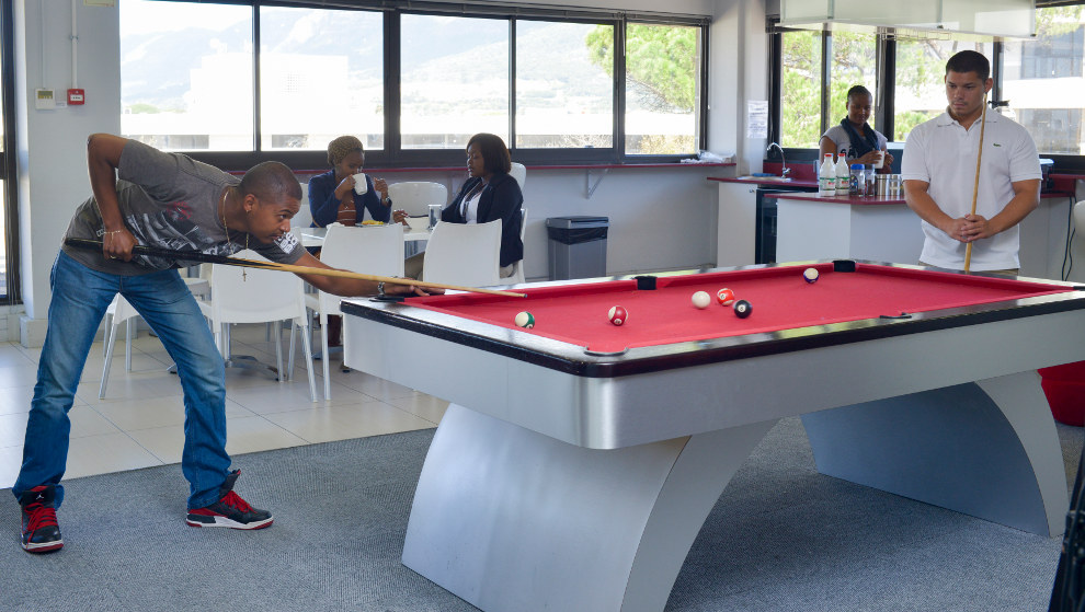 Coders play pool in the Red Panda offices. 